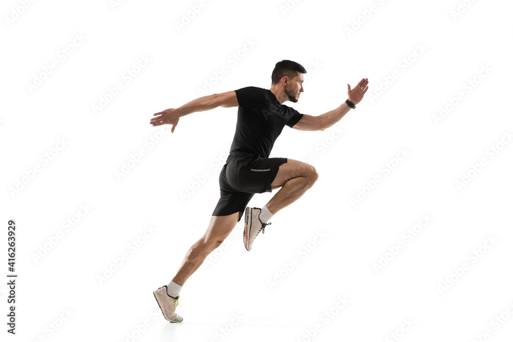 Obraz premium In jump. Caucasian professional sportsman training isolated on white studio background. Muscular, sportive man practicing. Copyspace. Concept of action, motion, youth, healthy lifestyle.