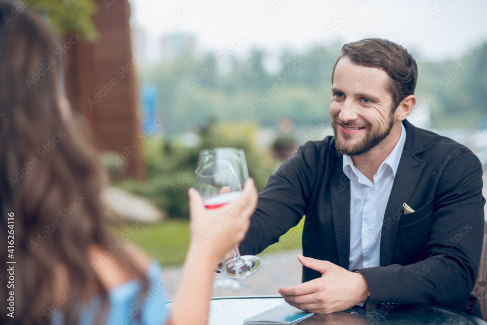 Happy man chatting with woman on date in cafe Happy man chatting with woman on date in cafe