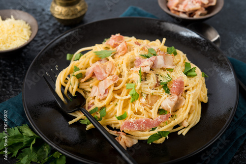 Spaghetti carbonara with bacon and parmesan on a plate