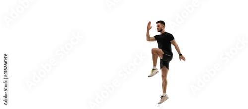 Flyer. Caucasian professional sportsman training isolated on white studio background. Muscular, sportive man practicing. Copyspace. Concept of action, motion, youth, healthy lifestyle.