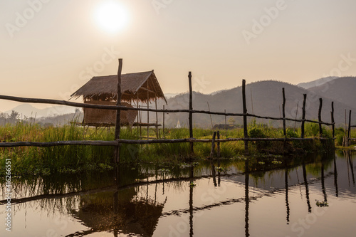 Boat tour in the floating gardens of Inle lake at sunset in Burma, Myanmar