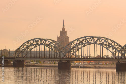 View of Latvian Academy of Sciences, Railway bridge and Daugava river on the sunrise in Riga, Latvia