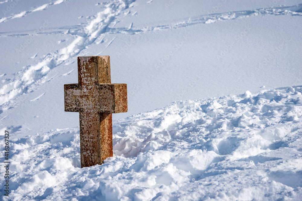 Ancient stone Christian cross in the snow on the Lessinia High Plateau (Altopiano della Lessinia). Malga San Giorgio, Bosco Chiesanuova municipality, Verona province, Veneto, Italy, Europe. Ancient stone Christian cross in the snow on the Lessinia High Plateau (Altopiano della Lessinia). Malga San Giorgio, Bosco Chiesanuova municipality, Verona province, Veneto, Italy, Europe.
