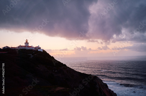 Famous lighthouse on Cabo da Roca, the western point of Europe. Beautiful sunset landscape with ocean shore.