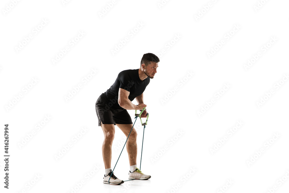 Stretching. Caucasian professional sportsman training isolated on white studio background. Muscular, sportive man practicing. Copyspace. Concept of action, motion, youth, healthy lifestyle. Stretching. Caucasian professional sportsman training isolated on white studio background. Muscular, sportive man practicing. Copyspace. Concept of action, motion, youth, healthy lifestyle.