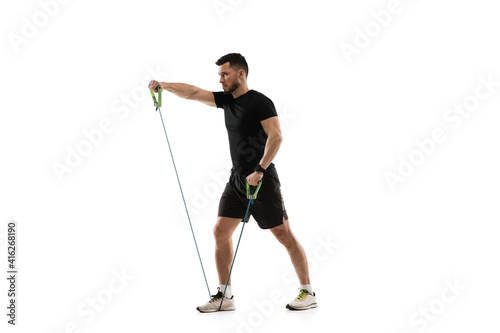 Stretching. Caucasian professional sportsman training isolated on white studio background. Muscular, sportive man practicing. Copyspace. Concept of action, motion, youth, healthy lifestyle. © master1305