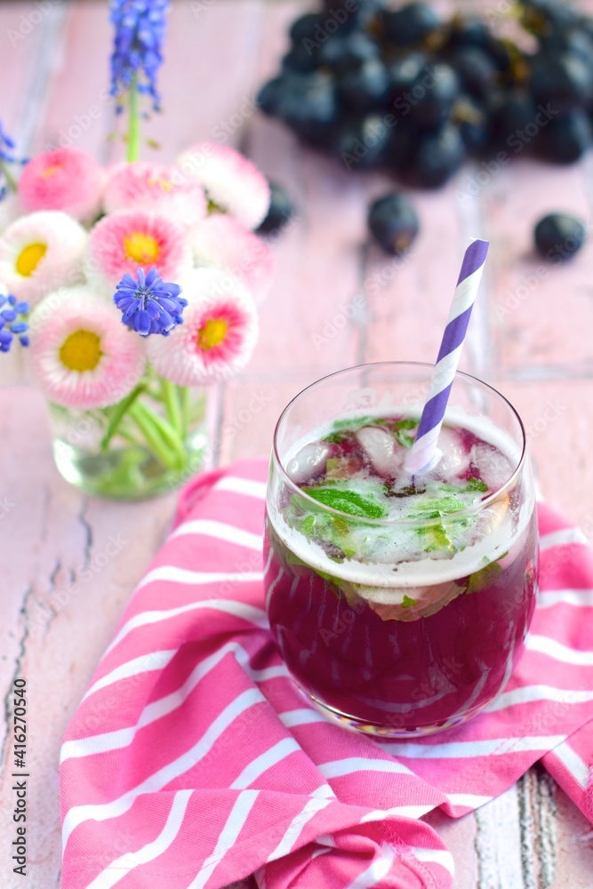 Grape mint soda mocktail with fresh grapes background Grape mint soda mocktail with fresh grapes background