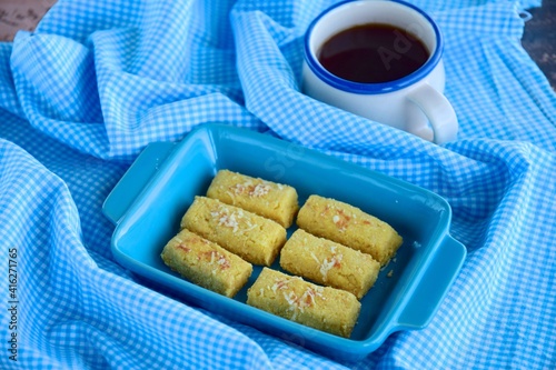 Kastengel or Kue Keju or Dutch Indonesian cheese stick cookies, served with coffee photo