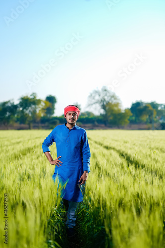 Young indian farmer at green wheat field © PRASANNAPIX