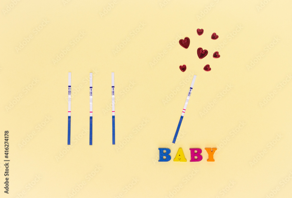 Negative and positive pregnancy test strips, red hearts and the inscription Negative and positive pregnancy test strips, red hearts and the inscription