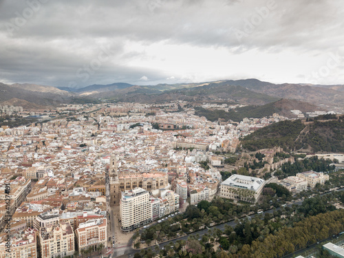 Aerial drone perspective of Andalusian city Malaga, touristic travel destination on Costa del Sol. Roof top , Cathedral of Malaga, Mountains in background, cloudy day