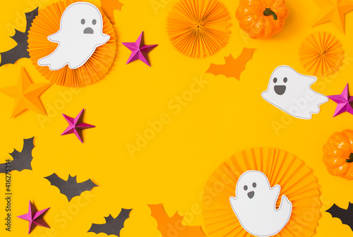 Halloween paper craft flat lay.Children seasonal art table top view.Kids hand craft concept.Bright halloween background with cutted out ghosts and paper crafts.