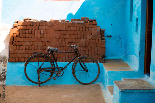 Katni / India 25 October 2017  bicycle parked at traditional rural house with door in Katni Madhya Pradesh India photo