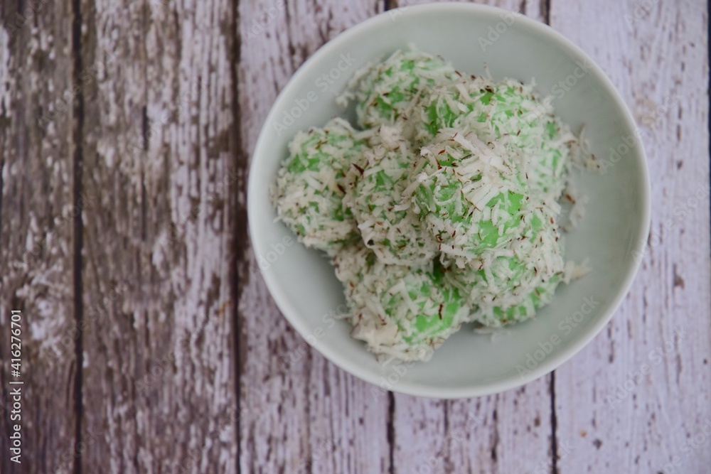 Indonesian Cuisine, Klepon or Traditional Pandanus Rice Balls Made From Glutinous Flour and Grated Coconut with Palm sugar Filling Indonesian Cuisine, Klepon or Traditional Pandanus Rice Balls Made From Glutinous Flour and Grated Coconut with Palm sugar Filling
