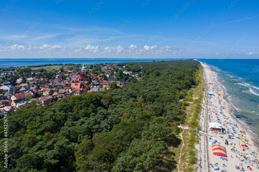 Sunbathing on the beach by the sea. Aerial drone view of  Baltic Sea coast in Hel peninsula, Jastarnia. Puck Bay in Poland