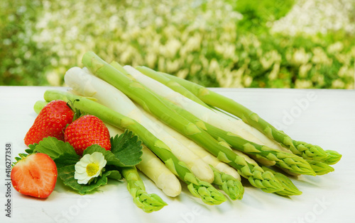 White and green asparagus with strawberries, copy space