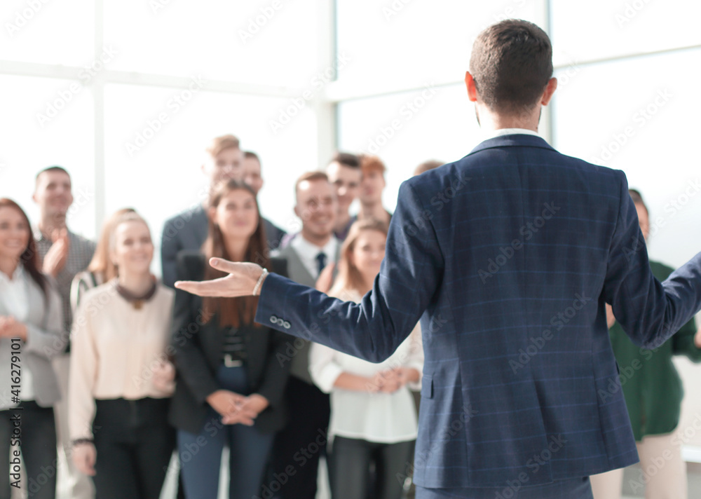 rear view. the young leader explaining something to his team rear view. the young leader explaining something to his team
