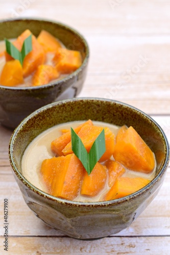 Kolak ubi - Indonesian dessert. Sweet potato cooked in coconut milk, palm sugar and pandan leaves