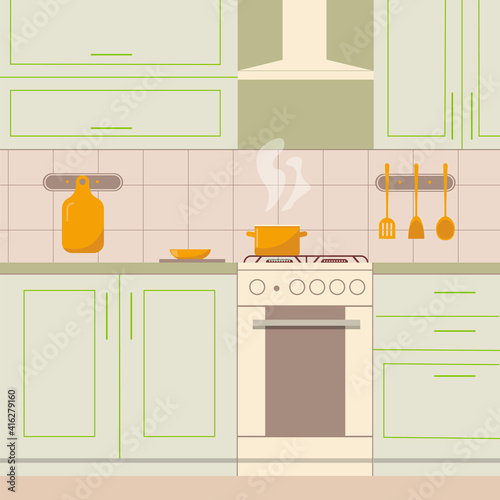 Cozy kitchen interior in olive color. Food is cooking on the gas stove.