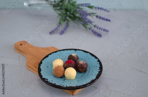 Chocolate cheese truffles, homemade chocolate. Delicious chocolate candies. Group of sweet chocolate truffles on gray background. Selective focus