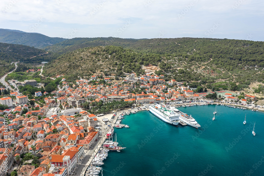 Aerial drone shot of cruise ferry at Adriatic sea port on Vis Island in Croatia summer