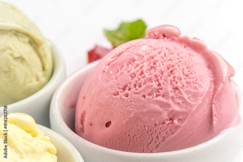 Strawberry ice cream ball in a bowl, isolated on a white background