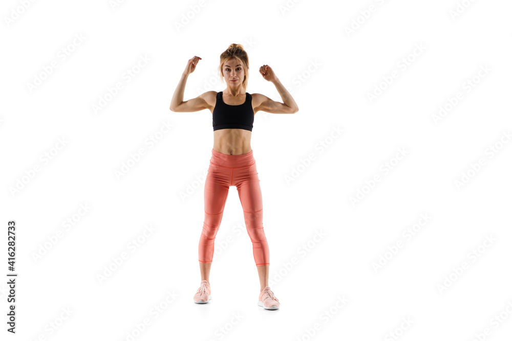Strong. Young caucasian female model in action, motion isolated on white background with copyspace. Concept of sport, movement, energy and dynamic, healthy lifestyle. Training, practicing. Strong. Young caucasian female model in action, motion isolated on white background with copyspace. Concept of sport, movement, energy and dynamic, healthy lifestyle. Training, practicing.