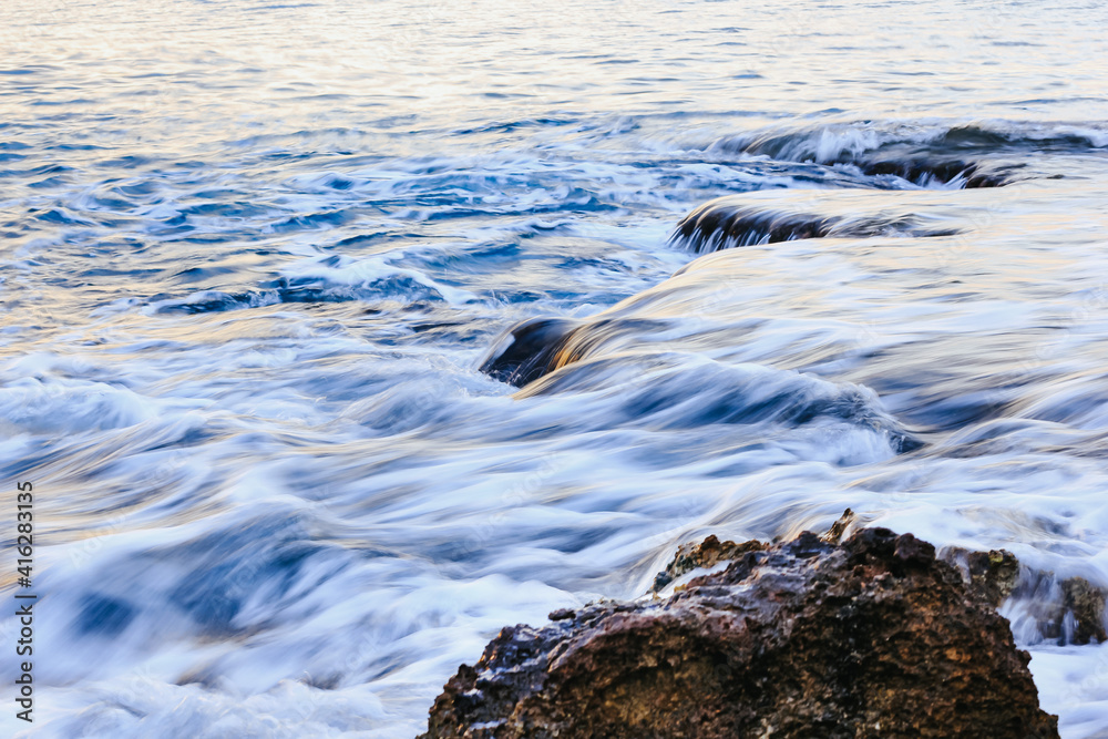 Fototapeta premium Blurred abstract natural background of sea water with waves and foam. Motion blur. Nature. 