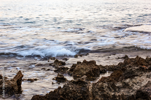 Blurred abstract natural background of sea water with waves and foam. Motion blur. Nature. 