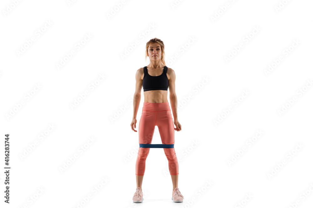 Stretching. Young caucasian female model in action, motion isolated on white background with copyspace. Concept of sport, movement, energy and dynamic, healthy lifestyle. Training, practicing. Stretching. Young caucasian female model in action, motion isolated on white background with copyspace. Concept of sport, movement, energy and dynamic, healthy lifestyle. Training, practicing.