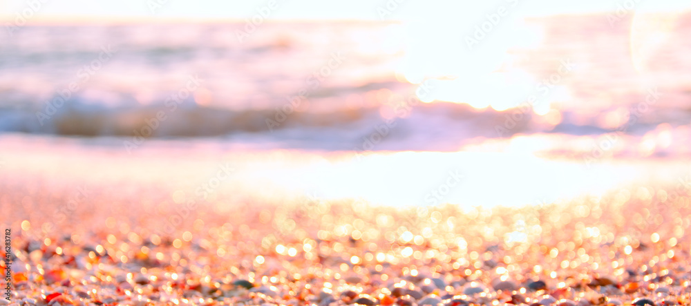 Abstract blurred background of summer sea shore in morning sunlight. Banner. Copy space. Summer vacation concept.