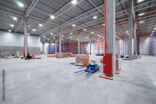 warehouse or hangar. Industrial building interior consist of polished concrete floor and closed door for product display or industry background.