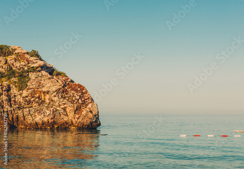 Colorful view on sea and cliff in the water