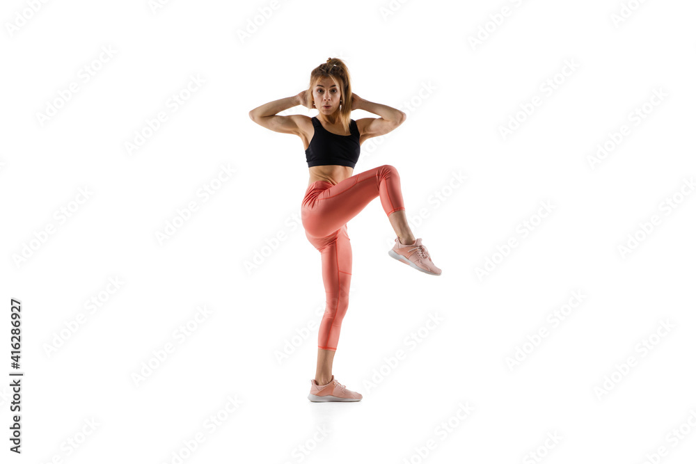 Strong. Young caucasian female model in action, motion isolated on white background with copyspace. Concept of sport, movement, energy and dynamic, healthy lifestyle. Training, practicing. Strong. Young caucasian female model in action, motion isolated on white background with copyspace. Concept of sport, movement, energy and dynamic, healthy lifestyle. Training, practicing.