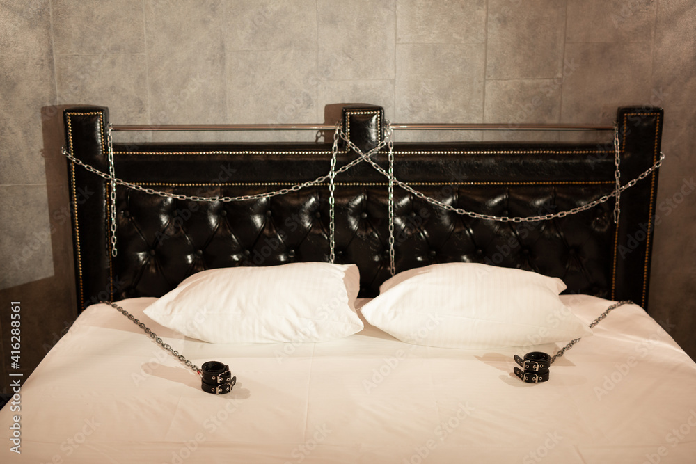 beautiful stylish bed with handcuffs for bdsm games Stock Photo | Adobe  Stock