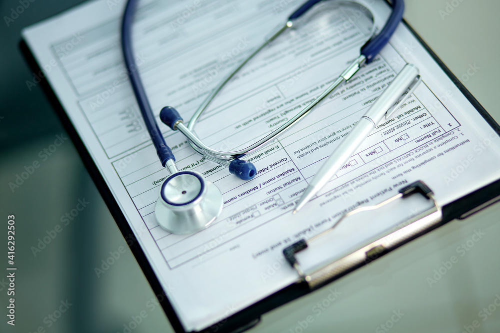 close-up. image of a stethoscope, pen and clipboard on the doctor's desktop. close-up. image of a stethoscope, pen and clipboard on the doctor's desktop.