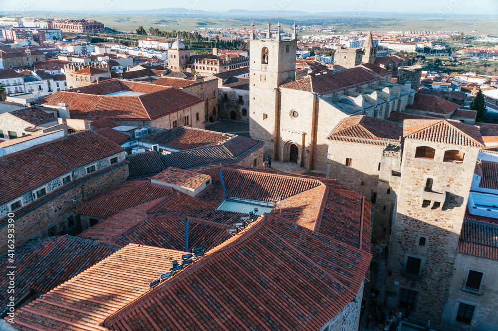 Aerial view of the old city with towers and bright orange roofs in Caceres, Extremadura, Spain