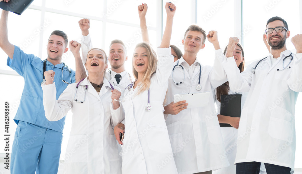 group of diverse medical employees showing their success group of diverse medical employees showing their success