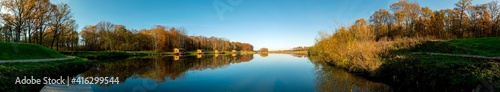 Fototapeta Naklejka Na Ścianę i Meble -  Forest lake with reflection under high mountains on a sunny spring day