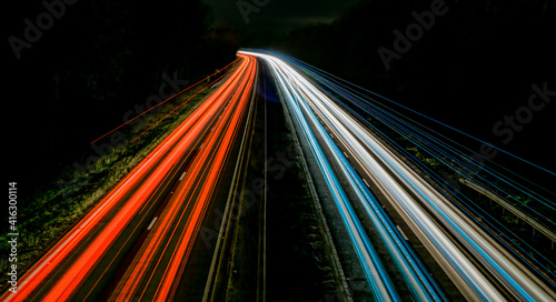 Fotografi Motorway light streaks with curve off into the distance