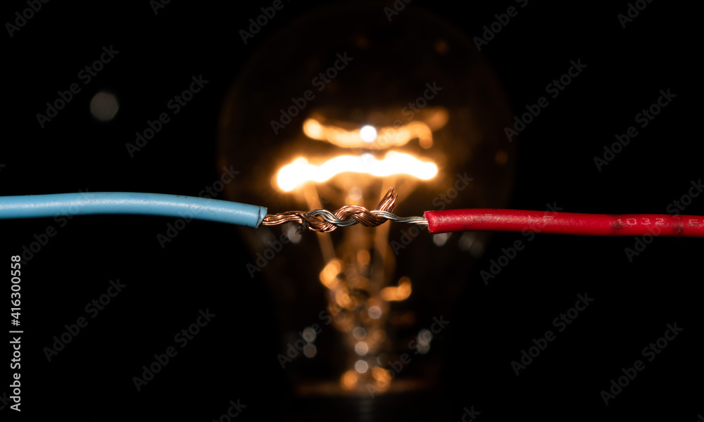Fototapeta premium connected cables lighting a light bulb