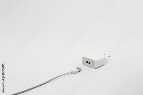 Universal charger for batteries for electronic products such as mobiles, tablets on white background
