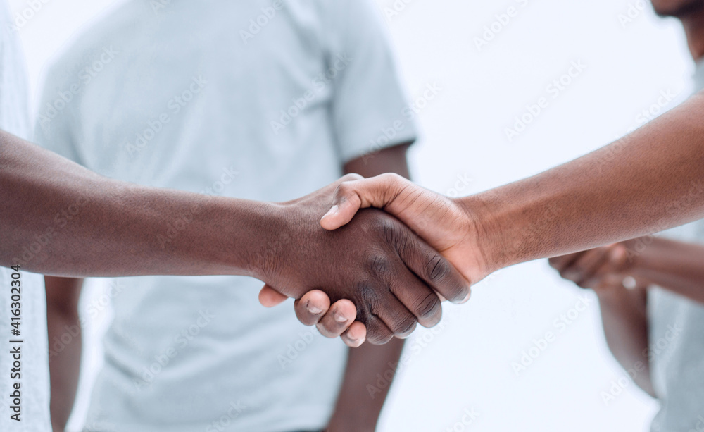smiling guys shaking hands. isolated on white