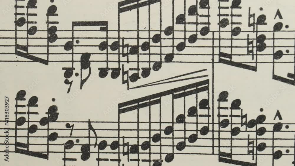 Stop motion, musical sheet music background.  Time lapse, musical background with a chaotic image of notes, musical signs.