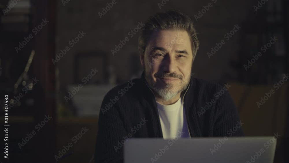 Older man working online with laptop computer at home sitting at desk. Home office, browsing internet, study room. Older man working online with laptop computer at home sitting at desk. Home office, browsing internet, study room.