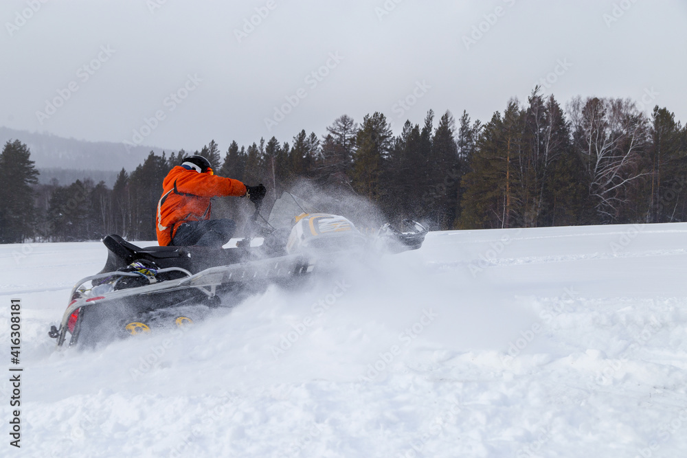 Athlete on a snowmobile.