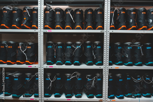 snowboard and ski boots on the shelf in the store, ski equipment