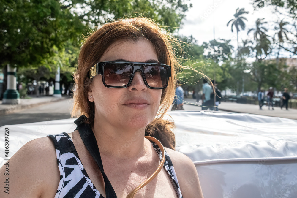 Middle age woman touring in Havana, Cuba Middle age woman touring in Havana, Cuba