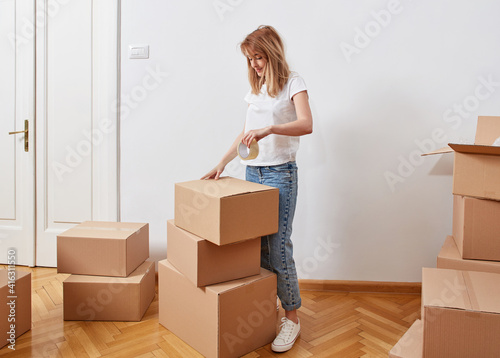 Woman packing to move in a new apartment