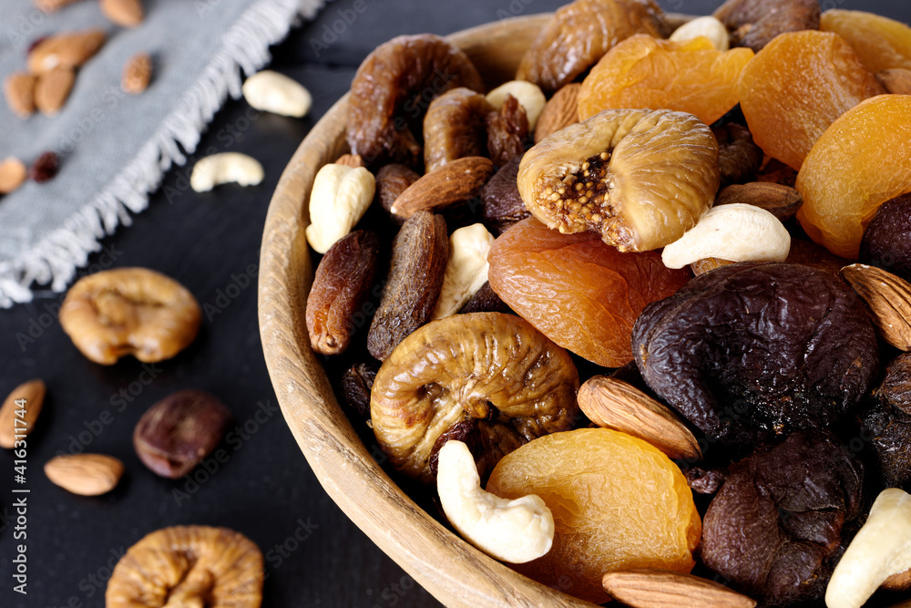 Wooden rustic bowl with variety of dry fruits and nuts healthy snacks. Wooden rustic bowl with variety of dry fruits and nuts healthy snacks.